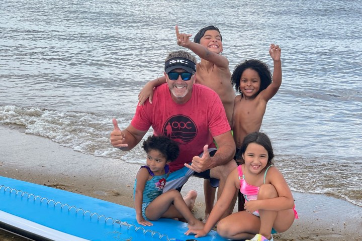 a group of people sitting at a beach