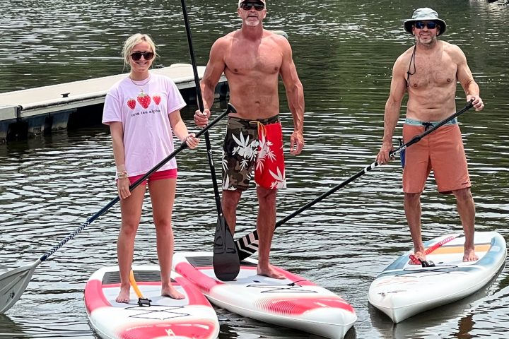 a group of people standing next to a body of water