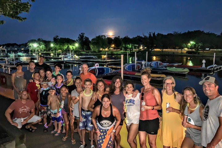 a group of people standing in front of a crowd posing for the camera