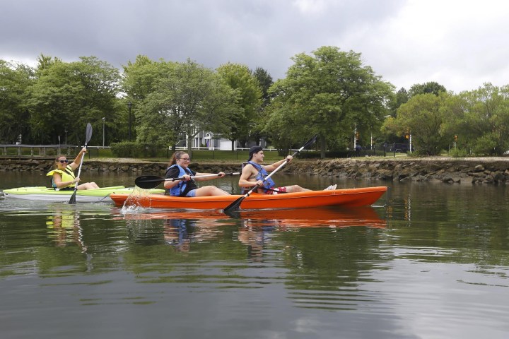 a group of people in a small boat in a body of water