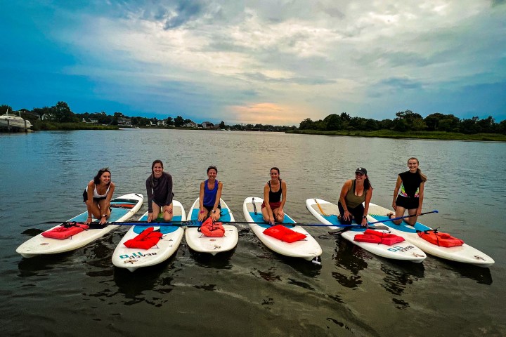 a group of people in a boat on a body of water
