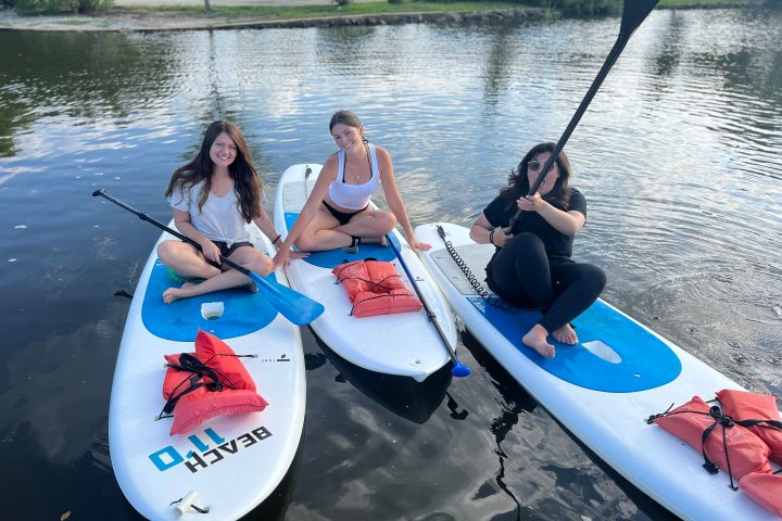 a group of people rowing a boat in a body of water