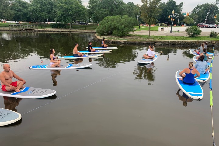 a group of people in a small boat in a body of water